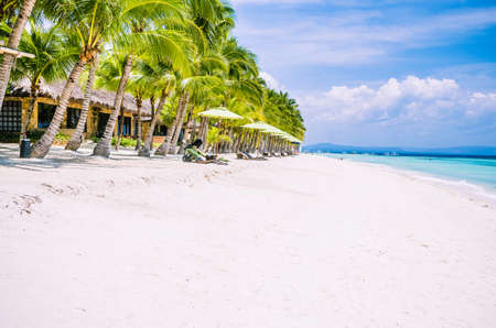 Tropical sandy beach at Panglao Bohol island with Sme Beach chairs under palm trees. Travel Vacation. Philippinesの写真素材