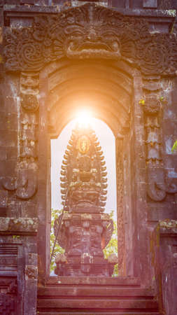 Gate in Pura Besakih Temple temple with Hindu Altar in sun light flaresの写真素材