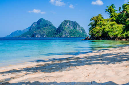 Sandy Beach with Palm Shadows, Huge Rocks in Background, El Nido, Palawan, Philippines