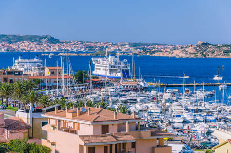 Port of Palau on sardinia island with farry and yacht boats. La Maddalena island in backgroundの写真素材