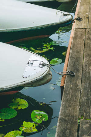 rent rowboat anchored at the pier of a lake in city park. Hamburgの写真素材