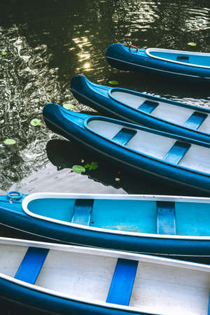 Canoe boats waiting for tourist hire on the lake in municipal city park. Hamburgの写真素材