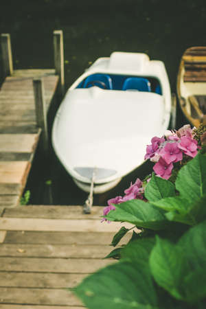 Rent Boat anchored at the pier of a lake in city park. Hamburgの写真素材