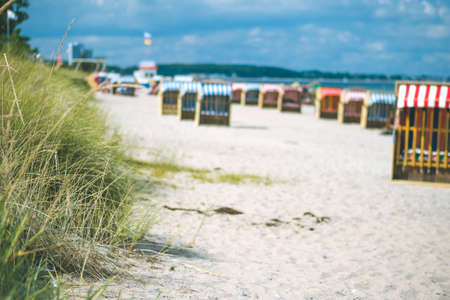 Colorful roofed chairs on sandy beach in Travemunde. Germanyの写真素材