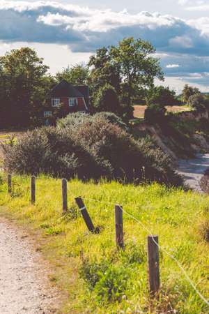 Baltic coastline. Escarpment slope lead to pebble beach. People walking along the shore hanseatic City of Luebeck - Travemuende, Germanyの写真素材