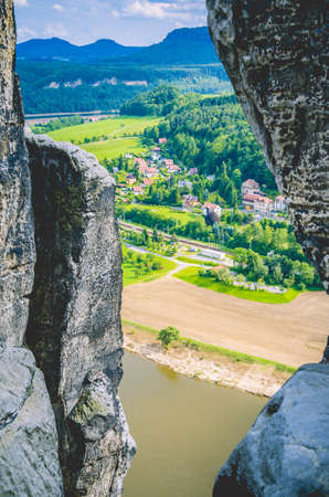 Small village on Elbe riverside. View between sandstone rocks in Bastai. Saxon Switzerland, Dresden, Germanyの写真素材