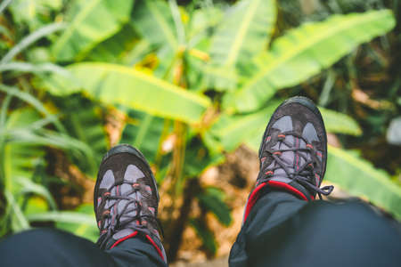 Hanging feet with trakking footwear after long hike from the mountains on Santo Antao Island, Cape...