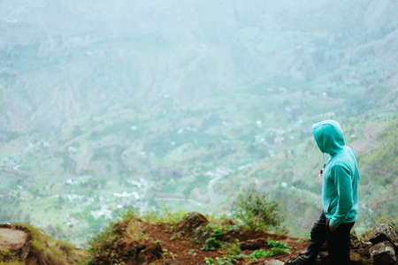 Traveler on the mountain edge overlooking the rural landscape of Paul valley. Santo Antao Island, Cape Verdeの写真素材