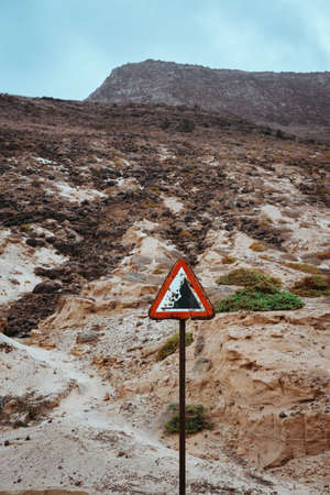 Warning road sign, beware of falling rocksの写真素材
