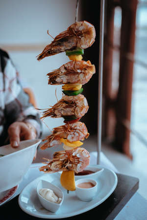 Shrimps oe prawns served on a vertical skewer in an restaurantの写真素材