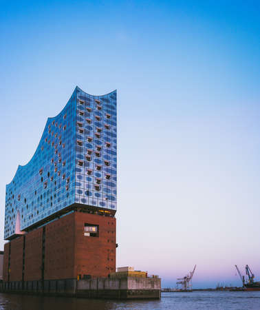 Shape of Elbphilharmonie on bright blue sky with some lilac sunset colors, Hamburg, Germanyの写真素材