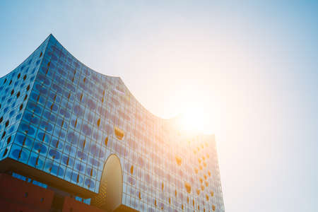 Hamburg, Germany - May 17, 2018: Elbphilharmonie, Panoramic shot - blue sky and bright sun light and flares from behind, Hamburg, Germanyのeditorial素材
