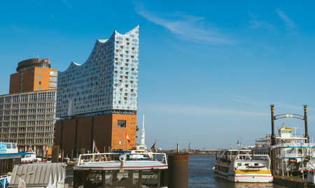 Hamburg, Germany - May 17, 2018: Panorama of hafencity - blue sky bright sky, business trade buildings. Some tourist boats in foreground, Hamburg, Germanyのeditorial素材