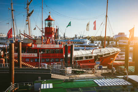 HAMBURG, GERMANY - April 18, 2018: Red fire patrol boat in the port of Hamburg with a restaurant on the boardのeditorial素材