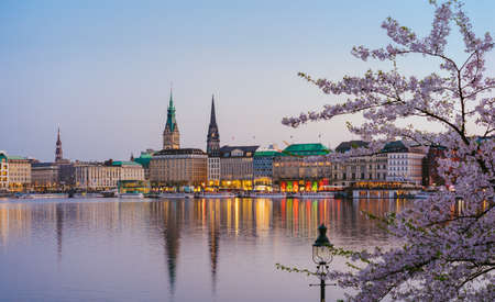 Beautiful panoramic view of Alster river and Hamburg town hall - Rathaus at spring earning evening...