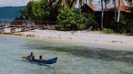 Arborek Island, Raja Ampat, October 10, 2016: local kids in a boat on Arborek Island in Raja Ampat, West Papua, Indonesia, near the famous Manta Point dive siteのeditorial素材
