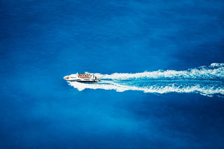 Top view of tourist boat sailing in the sea on full speedの写真素材