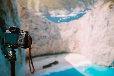 Digital camera on tripod capture photo of Shipwreck in Navagio beach in morning sun light. Famous visiting landmark location on Zakynthos island, Greeceの写真素材