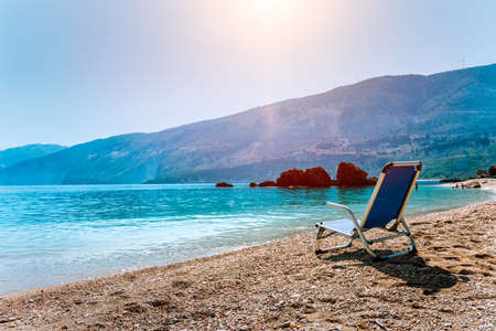 Blue sunchair on picturesque pebble beach, Kefalonia island, Greece. Travel relax vacation conceptの写真素材