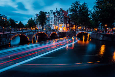 Famous Amsterdam Canal and magic light trails of a Vesselの写真素材