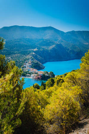 Top view to Assos village Kefalonia. Greece. Beautiful turquoise colored bay lagoon water surrounded by pine and cypress trees along the coastlineの写真素材