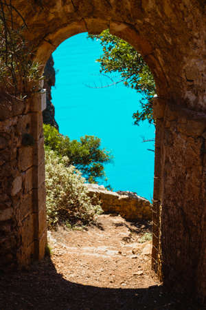 Ruins arch gate entrance of old fortress in Assos on Kefalonia island in Greeceの写真素材