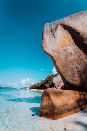 Huge beautifully shaped bizarre granite boulders in eveninf light at famous Anse Source dArgent...
