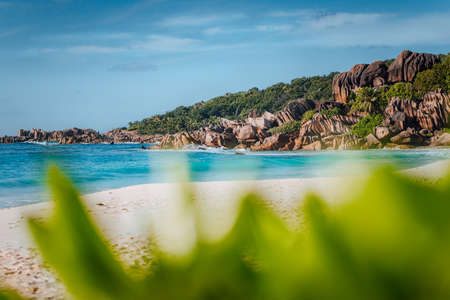 Picturesque Grand Anse tropical beach in La Digue, Seychelles with its famous granite rock...