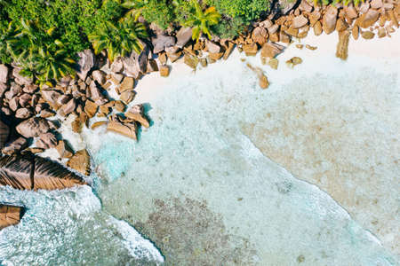 Aerial drone bird eye shot of beautiful paradise tropical Anse Cocos beach at La Digue, Seychellesの写真素材