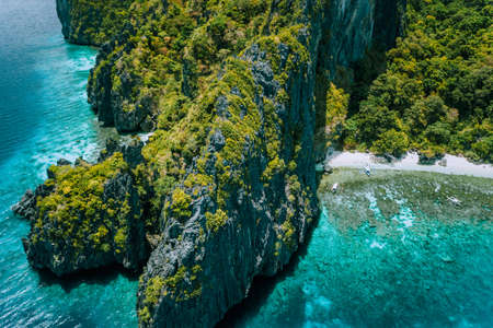 Aerial drone view of tropical island Entalula El Nido Palawan, Bacuit archipelago Philippines. Karst limestone rocky mountains surrounds blue bay with beautiful coral reefの写真素材