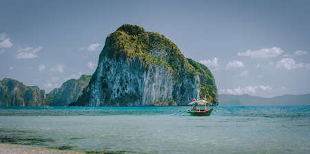 Panorama scenery of El Nido coastline. Philippino image Pinagbuyutan island in background and local...
