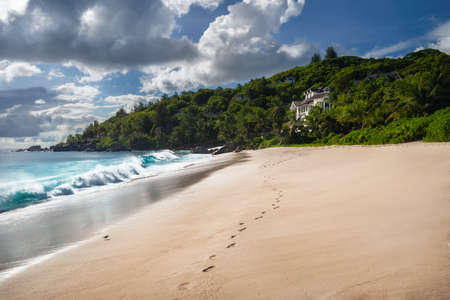 Exotic tropical beach Anse Takamaka on Seychelles islands, Mahe. Scenic view with impressive clouds on sunny dayの写真素材