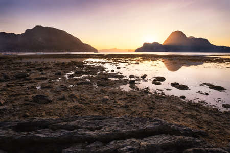 Sunset on El Nido village with silhouette of tropical islands in background. Palawan, Philippines.の写真素材