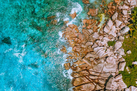 Aerial view of Seychelles Anse Cocos beach at La Digue Island. Pure crystal clear turquoise ocean water and bizarre granite rocks.の写真素材