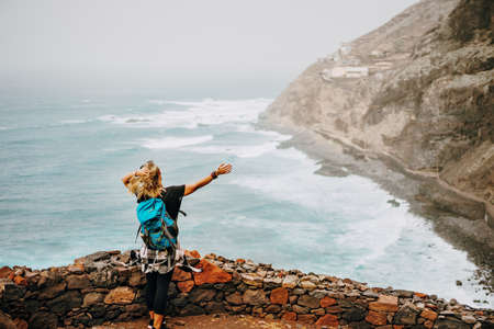 Santo Antao Island, Cape Verde. Tourist female enjoying view of atlantic ocean coastline on hiking route between Cruzinha and Ponta do Sol.の写真素材