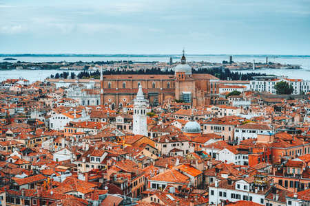 Panoramic view over rooftop of Venice, Italy. Traditional old houses with orange tilesの写真素材