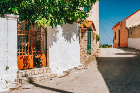 Narrow road with whitewash local houses on Kefalonia island, Greece.の写真素材