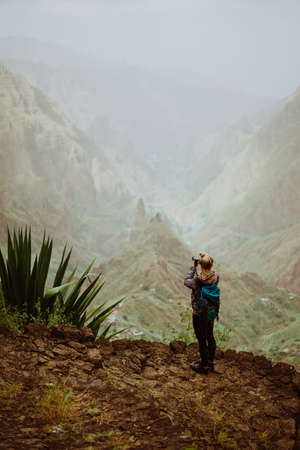 Santo Antao Island Cape Verde. Female tourist enjoying breathtaking view of Ribeira da Torre towering mountain topsの写真素材