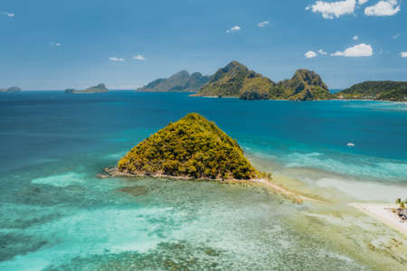 Aerial drone view of Las Cabanas beach in El Nido, Palawan
