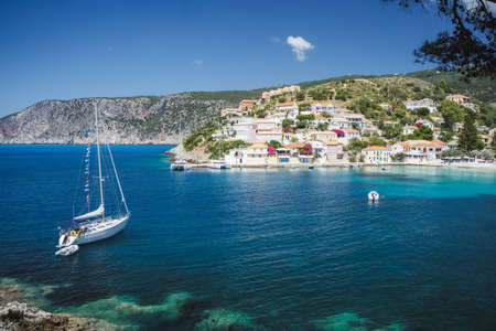 Sailing yacht boat in small bay of Assos cute town on Ionian coast, Kefalonia island, Greeceの写真素材