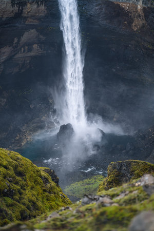 Close up of Haifoss waterfall in South Iceland. Water is crashing against the rocks on the bottom and splashing around. Defocused foregroundの写真素材
