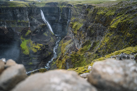 Granni waterfall fallen into deep canyon. Popular tourist travel destination in Iceland. Beauty of nature concept backgroundの写真素材