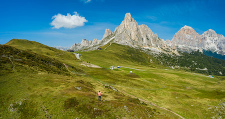 Aerial view of a man at Giau Pass enjoying Monte Nuvolau mountans. Dolomites, Italyの写真素材