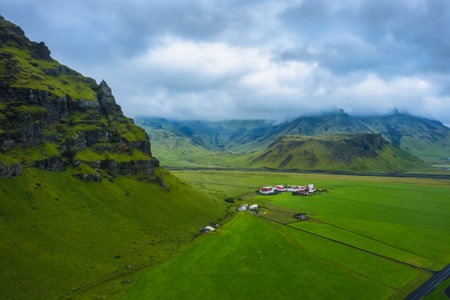 Aerial view of icelandic south coast on ring road. Landscape in Iceland at the day time. View from drone. Summer. Cloudy weather. Fresh grass on field. Travel and vacation imageの写真素材