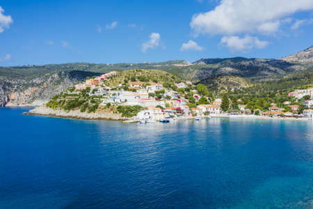 Assos picturesque fishing village from above, Kefalonia, Greece. erial drone view. Sailing boats...