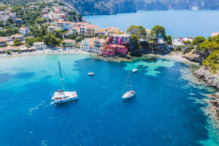 Assos picturesque fishing village from above, Kefalonia, Greece. Aerial drone view. Sailing boats...