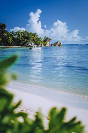 Seychelles. La Digue island famous Anse Source dArgent beach. Pleasure tourist vacation boat in ocean shallow lagoonの写真素材