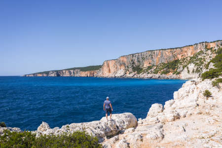 Aerial drone view of man enjoying rocky coastline close to Alaties Beach, Kefalonia, Ionian islands,...