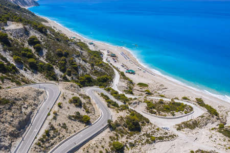 Serpentine road to Gialos Beach, Ionian Islands, Lefkada, Greece, aerial viewの写真素材