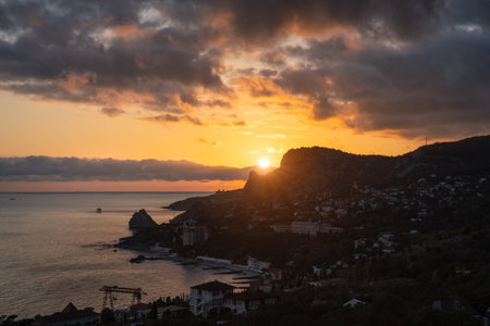 Sunet over Simeiz village with silhouette of Cat mountain and diva rock duroing golden hour. Southern coast of Crimeaの写真素材